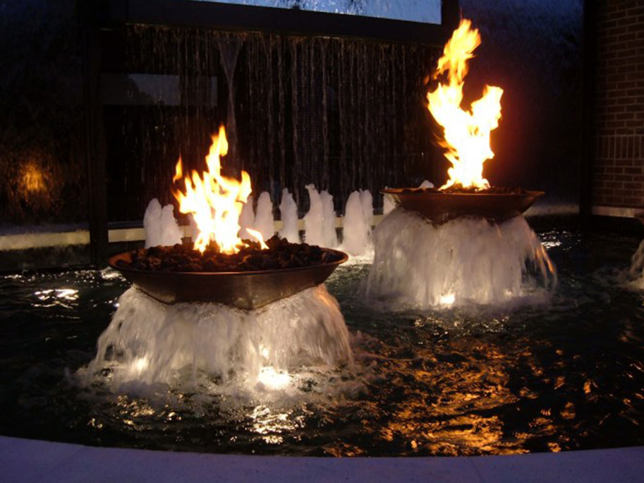 Fire Bowls fountain at night custom swimming pools champion pools west palm beach